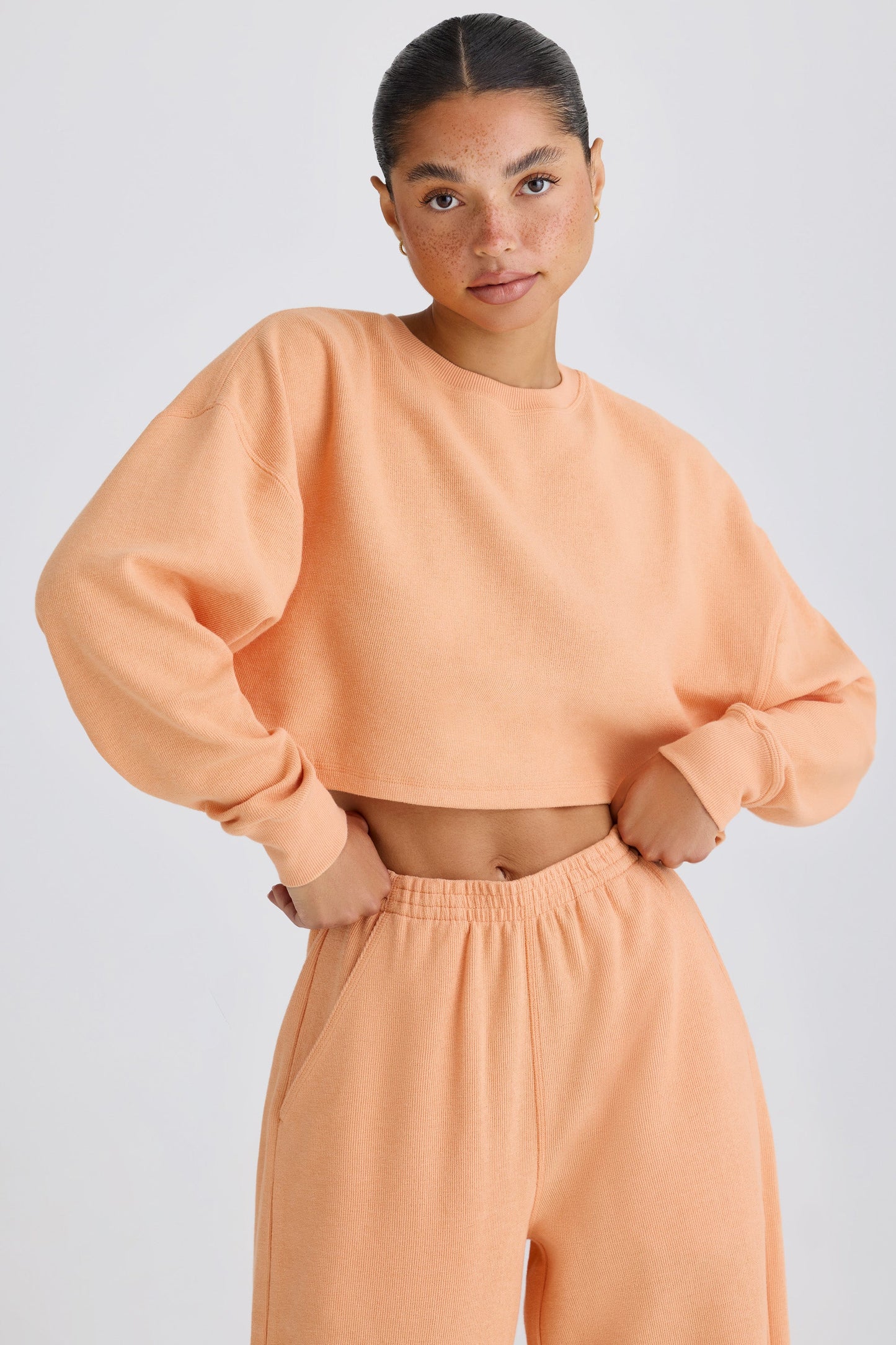 Textured Cotton Jersey Open-Back Cropped Sweatshirt in Peach